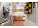 Spacious kitchen with stainless steel fridge and appliances, wood cabinets, and granite countertops at 5345 E Van Buren St # 258, Phoenix, AZ 85008