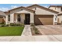 Charming single-story home featuring a well-manicured lawn, inviting entrance, and a convenient two-car garage at 6908 W Jasmine Trl, Peoria, AZ 85383