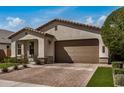 Charming single-story home with well-kept landscaping, a cozy entrance, and a convenient attached garage at 6908 W Jasmine Trl, Peoria, AZ 85383