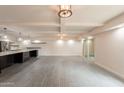 Open concept living room with tiled floors, beamed ceiling, and modern fixtures at 7960 E Camelback Rd # 110, Scottsdale, AZ 85251