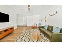 Open-concept living room with wood flooring, modern furniture, and ample natural light at 10832 N 37Th St, Phoenix, AZ 85028