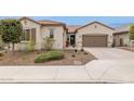 Charming single-story home featuring a well-manicured front yard and a two-car garage at 11609 W Andrew Ln, Peoria, AZ 85383