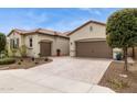 An inviting front exterior featuring a desert landscape, covered entrance, and attached two-car garage at 11609 W Andrew Ln, Peoria, AZ 85383