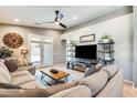 Inviting living room featuring a plush sectional sofa, stylish furnishings, and plenty of natural light at 11988 W Nadine Way, Peoria, AZ 85383