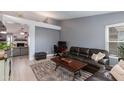 Comfortable living room featuring wood floors, neutral walls, and a modern furniture set at 1414 W Grovers Ave, Phoenix, AZ 85023