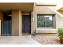 Inviting front entrance with security door, stone details, and a well-manicured garden area at 1432 W Emerald Ave # 648, Mesa, AZ 85202