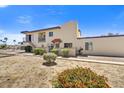 Exterior elevation of the property highlighting the architecture, balcony, and mature landscaping at 14414 N Boxwood Ln, Fountain Hills, AZ 85268