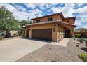 Beautiful two-story home with desert landscaping, tile roof, and a welcoming covered porch at 14733 N 159Th Dr, Surprise, AZ 85379