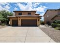 Charming two-story home featuring a three-car garage, tile roof, and desert landscaping at 14733 N 159Th Dr, Surprise, AZ 85379