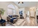 Bright living room featuring a vaulted ceiling, stylish furniture, and modern decor at 16513 N 68Th Dr, Peoria, AZ 85382