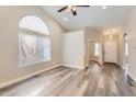 Bright living room featuring vaulted ceilings, a large window, and stylish flooring at 16513 N 68Th Dr, Peoria, AZ 85382