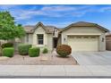 Beautiful single-story home with manicured landscaping and a spacious two-car garage in daylight at 1694 E Mia Ln, Gilbert, AZ 85298