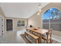 Bright dining area featuring neutral walls, unique lighting fixture, and arching window with desert views at 2218 E Desert Trumpet Rd, Phoenix, AZ 85048