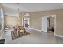 Open-concept dining area with beige walls and doorway leading to a bedroom at 2218 E Desert Trumpet Rd, Phoenix, AZ 85048