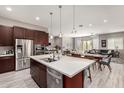 Open concept kitchen with stainless steel appliances and views into the living and dining areas at 22434 S 226Th Pl, Queen Creek, AZ 85142