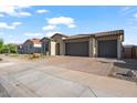 Lovely home featuring a three-car garage and low-maintenance landscaping at 22473 E Twilight Dr, Queen Creek, AZ 85142