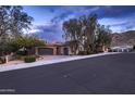 Charming single-story home with a two-car garage, mature landscaping, and a well-maintained front yard at 25929 N 84Th Ln, Peoria, AZ 85383