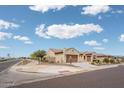 Exterior shot of the home from the street, showcasing the landscaping and neighborhood at 26190 W Siesta Ln, Buckeye, AZ 85396
