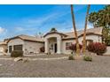 Attractive single-story home with a well-kept yard and desert landscaping with palm trees at 2732 E Hillery Dr, Phoenix, AZ 85032
