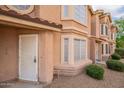 Charming townhome showcasing a stucco exterior, well-manicured landscaping, and decorative window accents at 2875 W Highland St # 1152, Chandler, AZ 85224