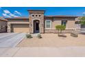 Inviting single-story home with a stone-accented entrance, desert landscaping, and a two-car garage at 3028 W T Ryan Ln, Phoenix, AZ 85041