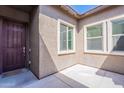 Welcoming covered front porch with a dark wood door and large windows offering ample natural light at 3028 W T Ryan Ln, Phoenix, AZ 85041