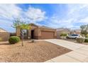 Single-story home featuring desert landscaping, neutral color palette, and a two-car garage at 30993 W Indianola Ave, Buckeye, AZ 85396