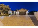 Beautiful home exterior with paver driveway, desert landscaping, and a well-maintained yard at 3381 E Azalea Dr, Chandler, AZ 85286