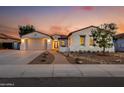 Beautiful single-story home with a garage and desert landscaping at sunset at 3673 E Horseshoe Dr, Chandler, AZ 85249