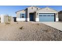 Charming single-story home featuring a blue garage door, shuttered window and neutral stucco at 37458 W San Clemente St, Maricopa, AZ 85138