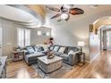 Comfortable living room with a sectional sofa, a ceiling fan, and bright natural light at 4539 W Beautiful Ln, Laveen, AZ 85339