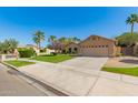 Well-kept home with a lush green lawn, mature landscaping, and a two-car garage at 4901 S Vista Pl, Chandler, AZ 85248