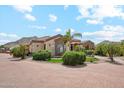 Beautiful home with tiled roof, manicured landscaping, and circular driveway at 5523 W Creekside Ln, San Tan Valley, AZ 85144