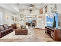 Open-concept living room with hard wood floors, comfortable furniture, and natural light at 5523 W Creekside Ln, San Tan Valley, AZ 85144