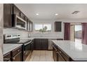 Kitchen features modern stainless appliances and a center island with countertops at 559 W Viola St, Casa Grande, AZ 85122