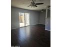 Bright living room with sliding glass doors, wood-look flooring, and ceiling fan at 600 S Dobson Rd # 53, Mesa, AZ 85202