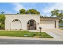 Charming home featuring a gated entrance, stucco walls, and lush lawn at 6122 E Harvard St, Scottsdale, AZ 85257