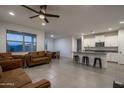 Open living space with tile floors and a view into the kitchen with bar stool seating at 6732 W Pedro Ln, Laveen, AZ 85339