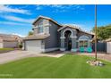 Charming two-story home featuring a well-manicured lawn and a classic grey facade at 7344 E Nopal Ave, Mesa, AZ 85209