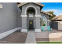 Inviting front entrance with decorative wreath, seating, and charming architectural details at 7344 E Nopal Ave, Mesa, AZ 85209