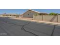 A street view showing the side of the property with desert landscaping and block wall at 7925 E Monte Ave, Mesa, AZ 85209