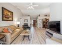 Bright living room with high ceilings, light wood floors, and comfortable furniture at 8405 W Utopia Rd, Peoria, AZ 85382