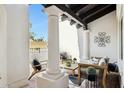 Cozy outdoor patio featuring stylish seating, decorative pillars, and tranquil natural light at 8719 E San Marcos Dr, Scottsdale, AZ 85258