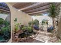 Picturesque courtyard boasting a tranquil pond, lush greenery, and arched access with comfortable patio seating at 9019 N 87Th Way, Scottsdale, AZ 85258