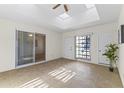 Bright sunroom with tile floor, ceiling fan, and skylights offers a cozy space for relaxation at 9202 N 107Th Ave, Sun City, AZ 85351