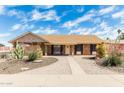 Charming brick home featuring manicured landscaping, a cozy front porch, and a welcoming entrance at 1240 E Indigo St, Mesa, AZ 85203