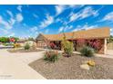 A well-maintained home with mature landscaping and a manicured front yard at 1240 E Indigo St, Mesa, AZ 85203