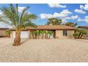 Charming brick home featuring desert landscaping and well-manicured palm trees at 14017 N 40Th Ave, Phoenix, AZ 85053