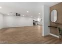 Open-concept living room featuring stylish wood flooring, lots of space, and a modern design at 14017 N 40Th Ave, Phoenix, AZ 85053