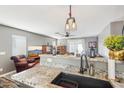 Open kitchen area with granite countertops overlooking the living area and pendant lighting at 15136 N 162Nd Ln, Surprise, AZ 85379